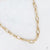 Gouden stainless steel schakelketting met ovale schakels en verstelbare lengte.