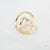 Gouden stainless steel ring met open spiraalvorm en glanzende afwerking.