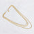 Gelaagde gouden stainless steel ketting met drie verschillende schakels.